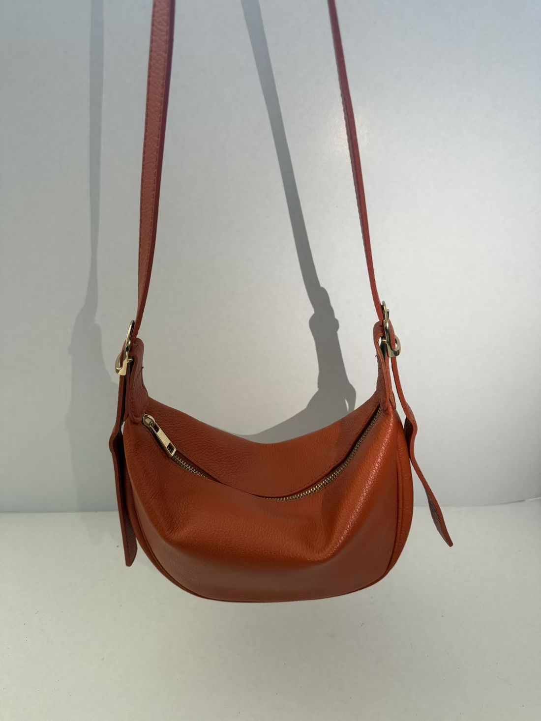 Half-moon crossbody — vegetable-tanned calf